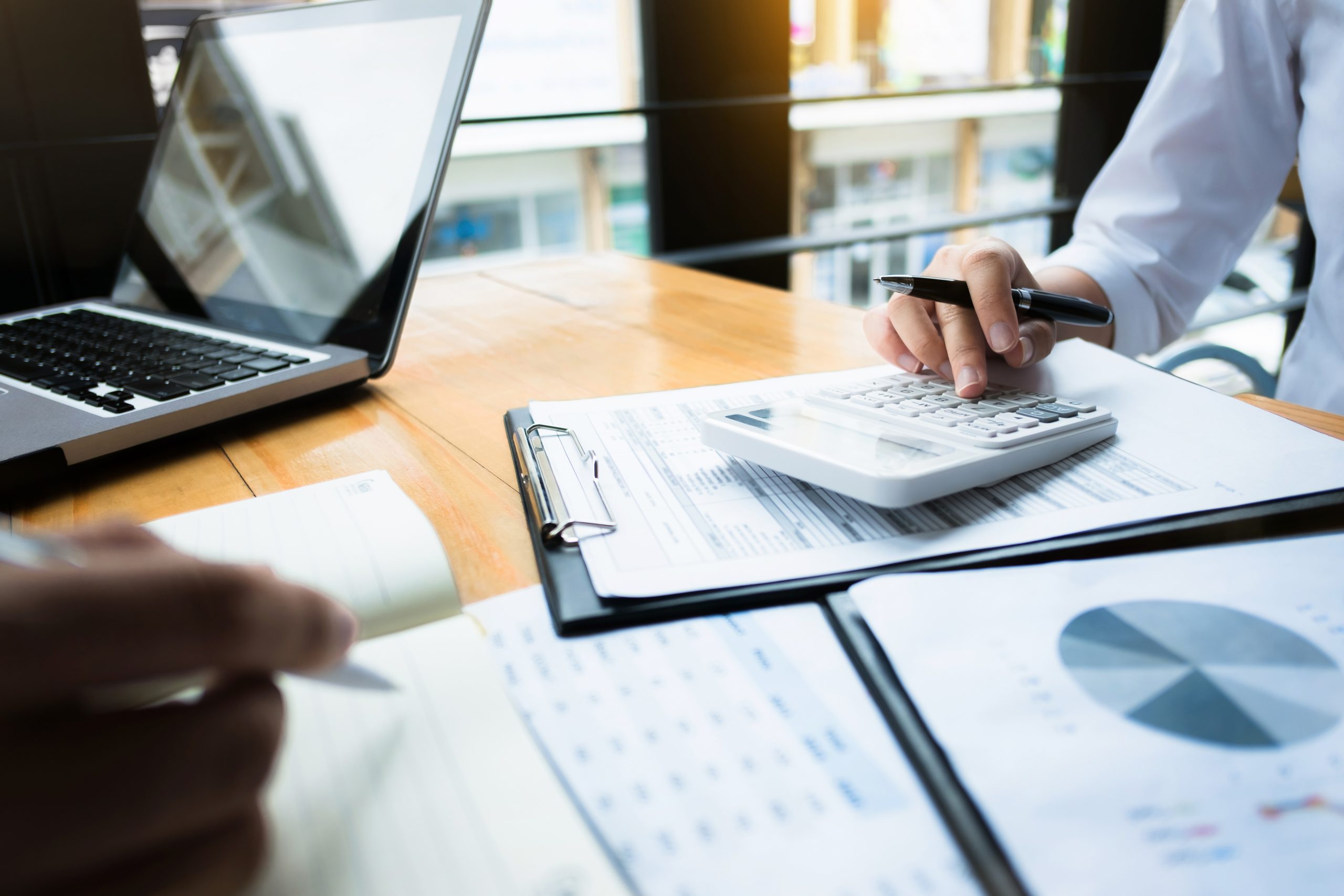 business audits using a calculator financial data investment fund at a workplace, wealth concept business audits using a calculator financial data investment fund at a workplace, wealth concept