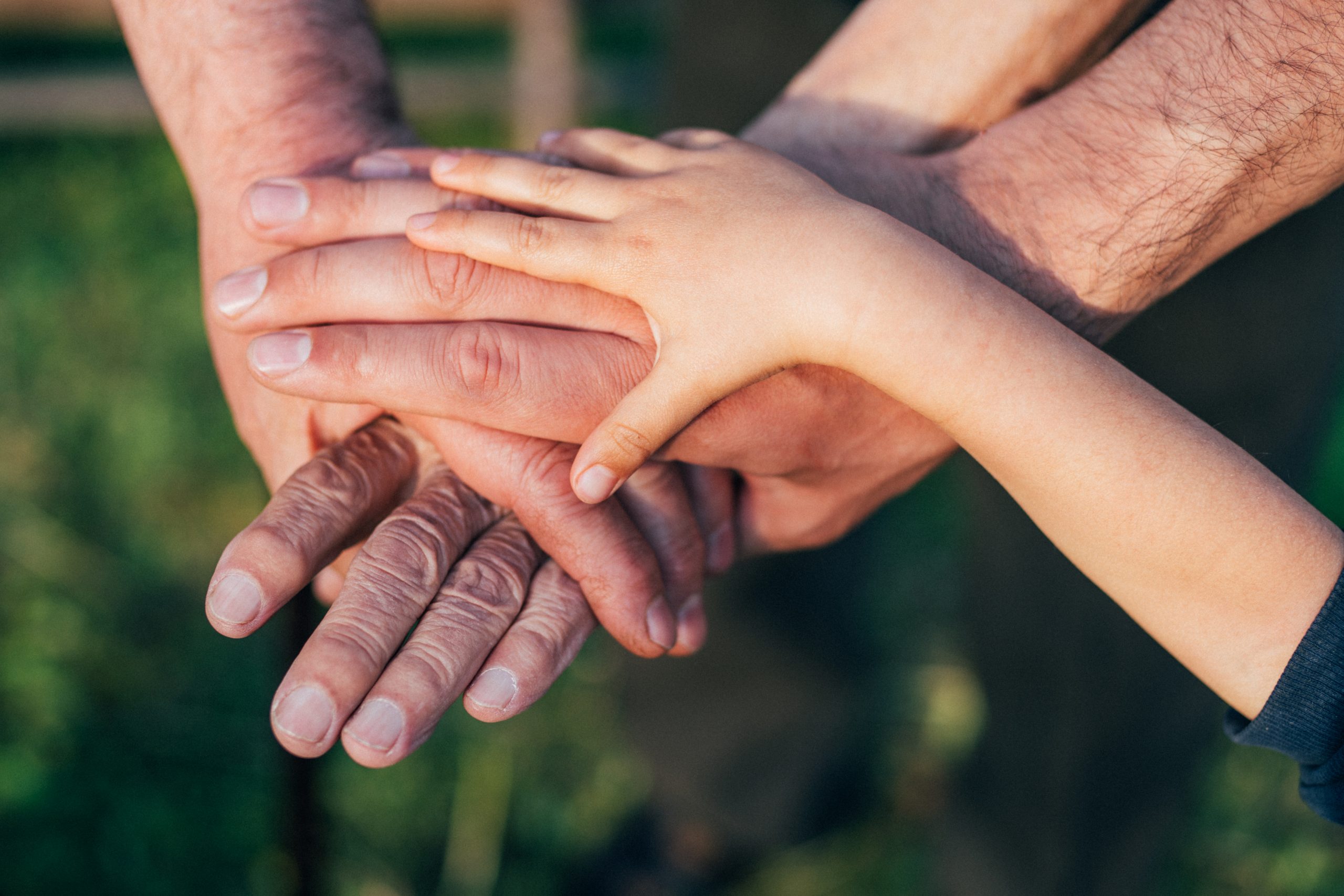 The best family in the world! Close-up of group of people with stacking hands.